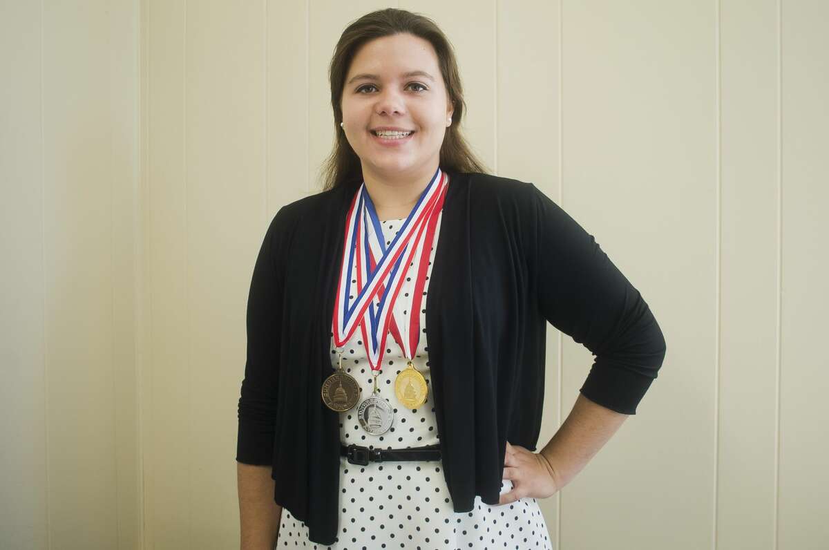 Emily Deese of Midland poses for a portrait with her bronze, silver and gold Congressional Award medals for service to the community on Wednesday, July 5, 2017 at the Midland Daily News offices.