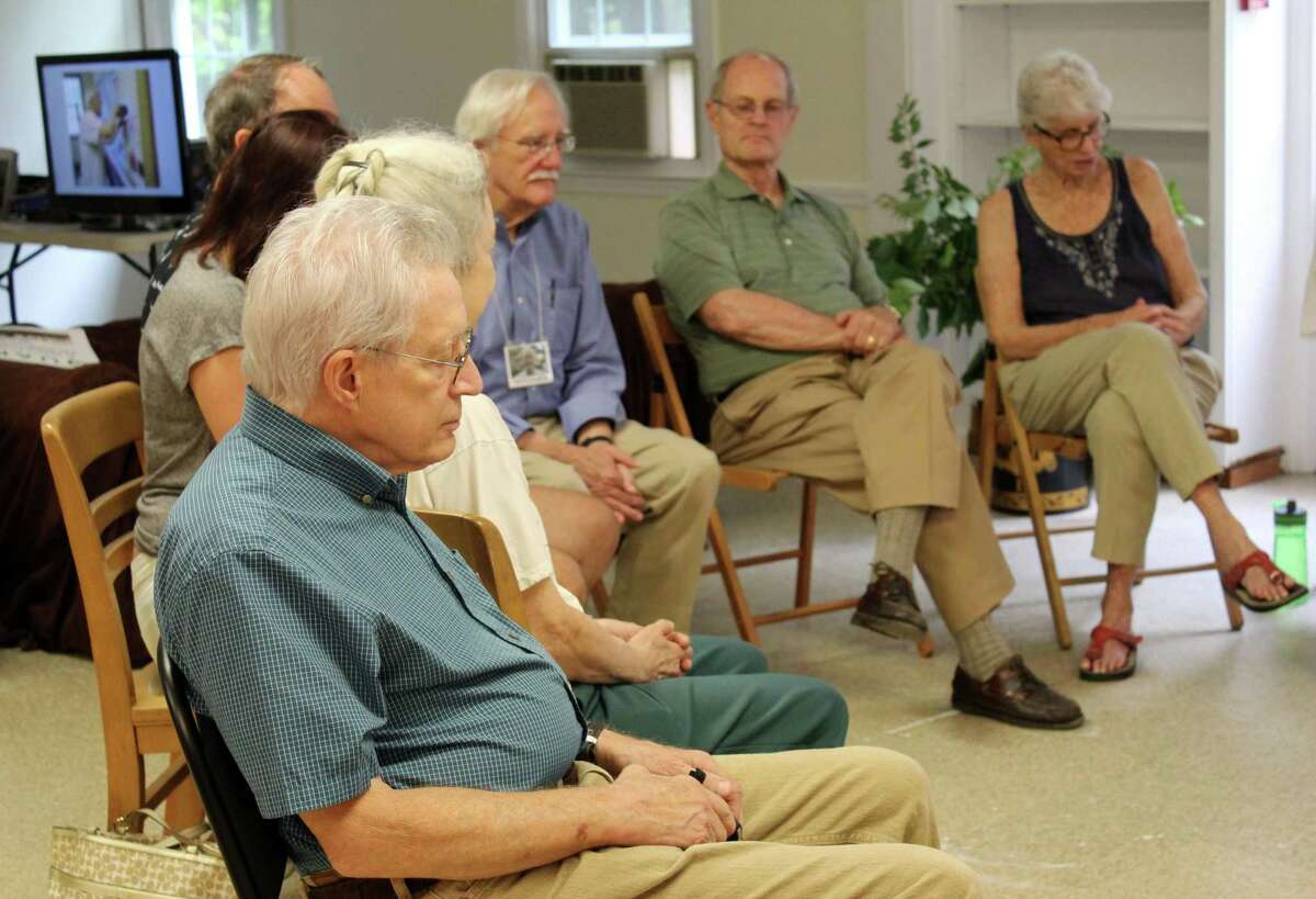 Sean Higgins and other members of the Wilton Monthly Meeting spend time in prayer at the beginning of its 75th anniversary party on Saturday, July 15, 2017, at 317 New Canaan Road.