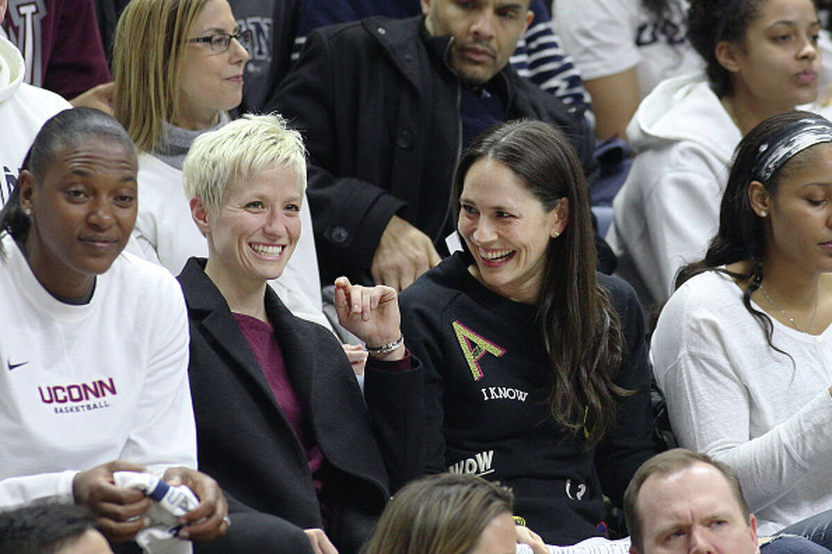 STORRS, CONNECTICUT- FEBRUARY 13: United States soccer player Megan Rapinoe with former UConn basketball players Sue Bird and Maya Moore, watching the UConn side as they go for their one hundreth consecutive win during the UConn Huskies Vs South Carolina Gamecocks NCAA Women's Basketball game at Gampel Pavilion, on February 13th, 2017 in Storrs, Connecticut. (Photo by Tim Clayton/Corbis via Getty Images)