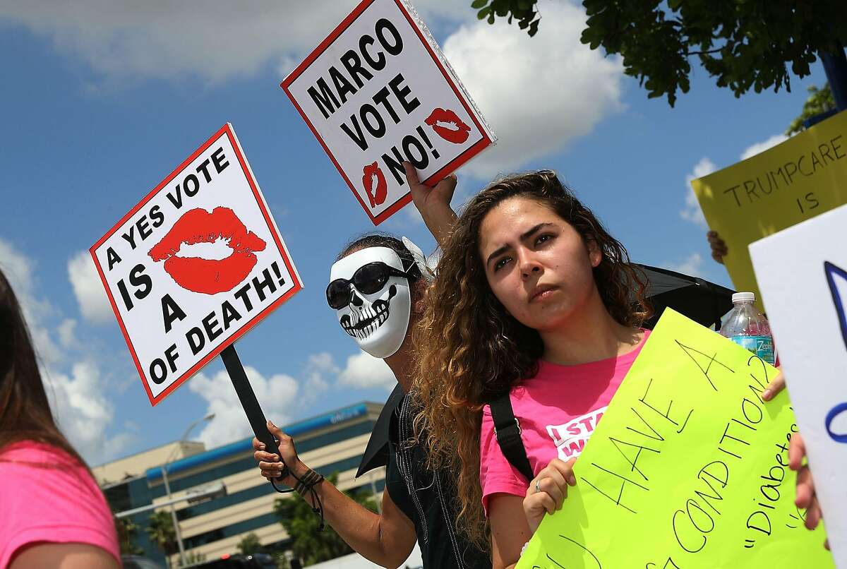 DORAL, FL - JUNE 28: Protesters gather at U.S. Sen. Marco Rubio's (R-FL) office on June 28, 2017 in Doral, Florida. The protesters are demanding Rubio vote against the Senate health care proposal that would make drastic cuts to Medicaid and, according to the non-partisan Congressional Budget Office, make health insurance coverage unaffordable for millions. (Photo by Joe Raedle/Getty Images)