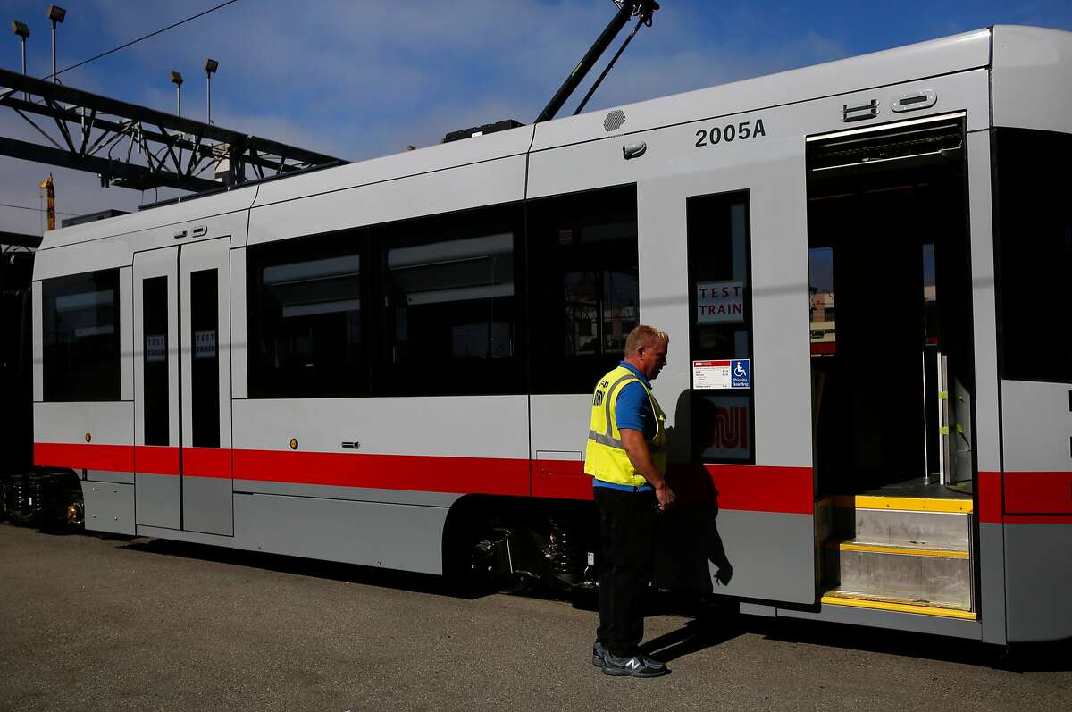 Assistant Supervisor David McElroy opens the door to a new MUNI train during a media tour at MUNI Metro East Maintenance Facility July 20, 2017 in San Francisco, Calif.