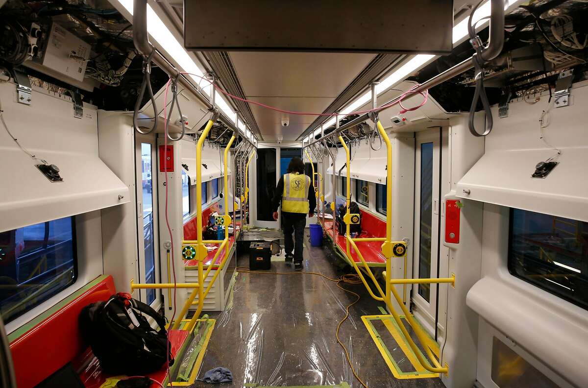 Siemens Technician Jonathan Binaday walks through a new MUNI train as he and other Siemens workers test its systems at MUNI Metro East Maintenance Facility July 20, 2017 in San Francisco, Calif.