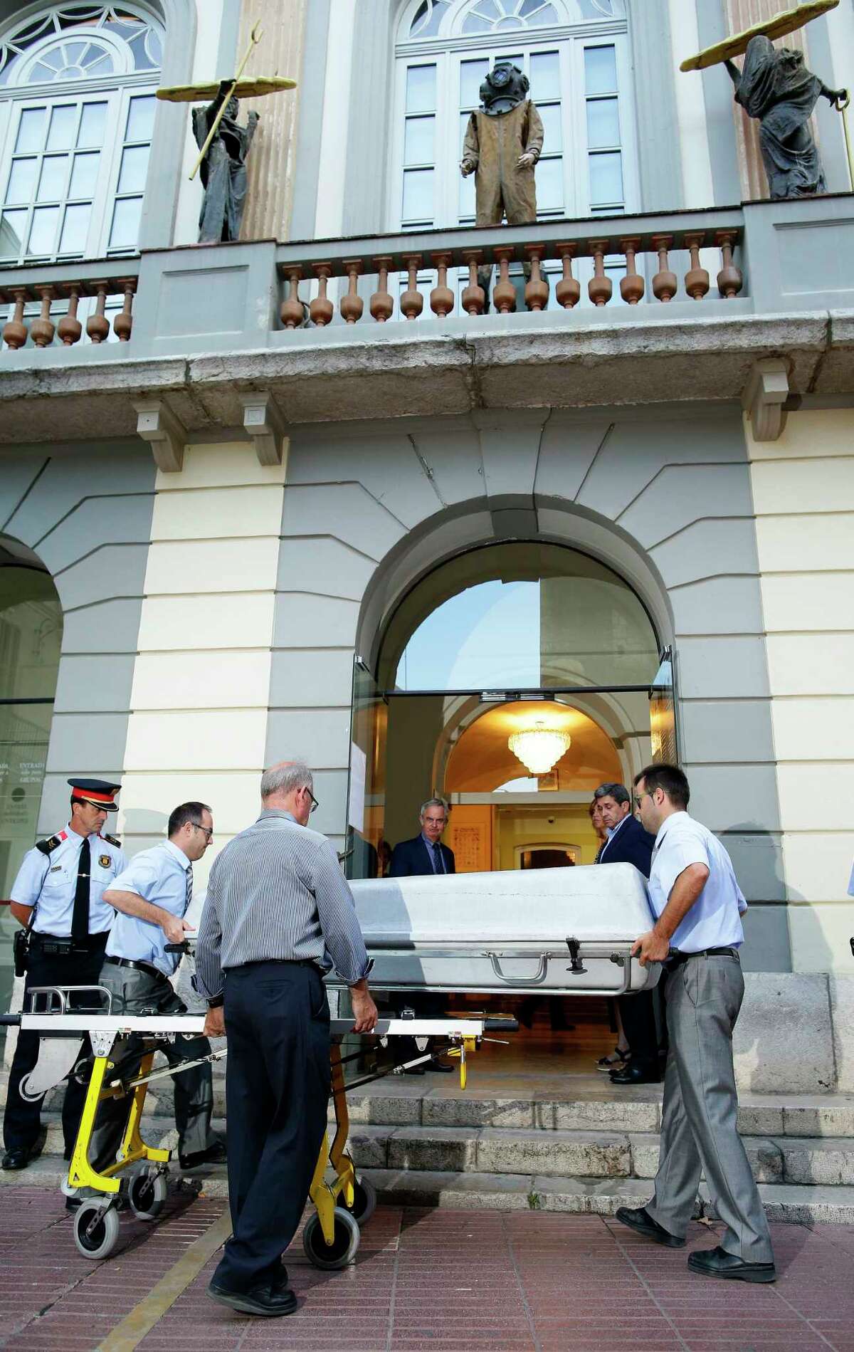 Workers bring a casket to the Dali Theater Museum in Figueres, Spain, Thursday, July 20, 2017. Salvador Dali's eccentric artistic and personal history took yet another bizarre turn Thursday with the exhumation of his embalmed remains in order to find genetic samples that could settle whether one of the founding figures of surrealism fathered a daughter decades ago. (AP Photo/Manu Fernandez)