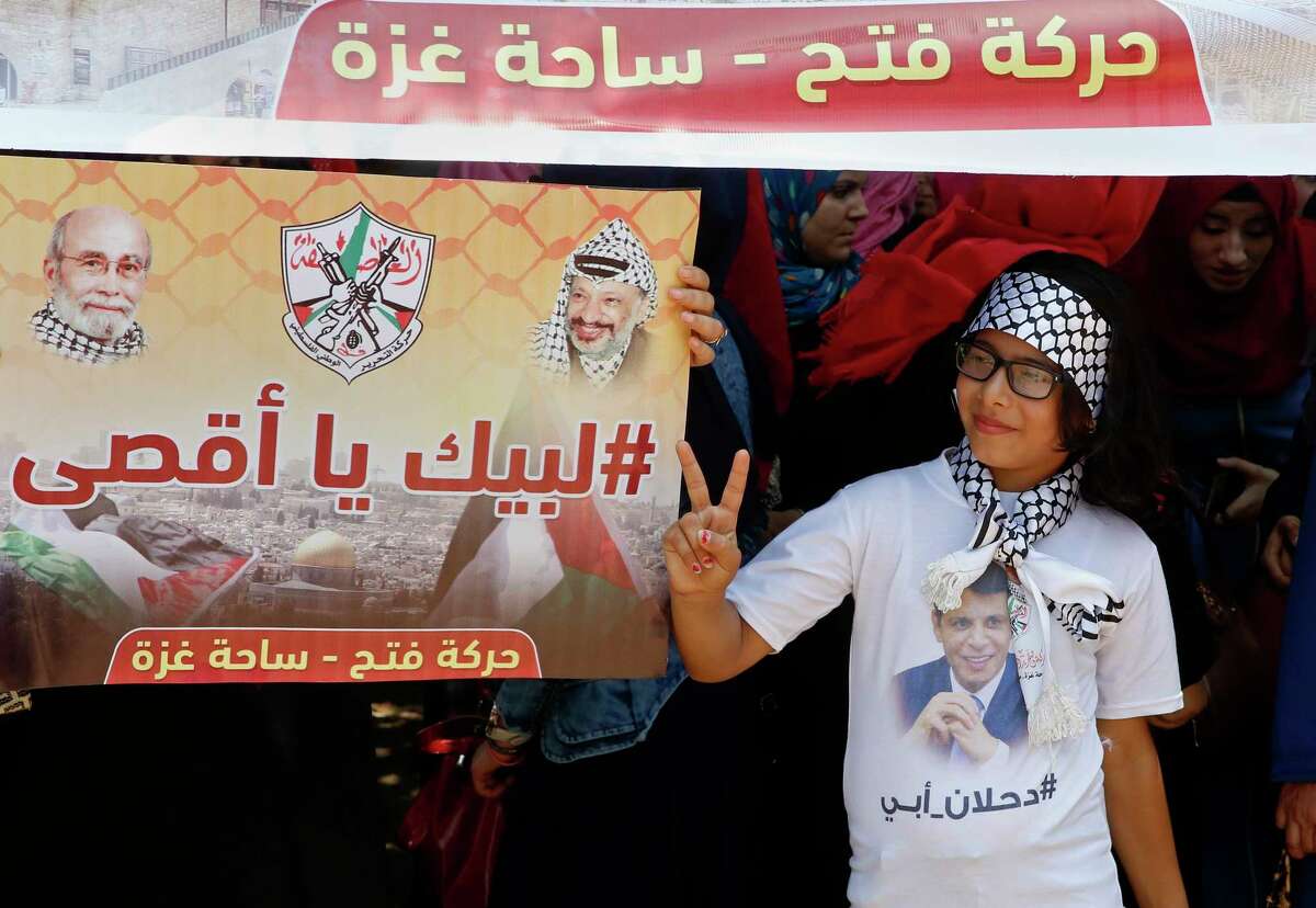 A girl wears a t-shirt with a photo of exiled former Gaza strongman Mohammed Dahlan during a protest against metal detectors that Israel has installed at the Al-Aqsa Mosque compound in Jerusalem, in Gaza City, Thursday, July 20, 2017. A Gaza power-sharing deal between Dahlan and Hamas, two former arch foes, is slowly taking shape on the ground and could lead to big changes in the Hamas-ruled territory, including an easing of a decade-long border blockade. (AP Photo/Adel Hana)