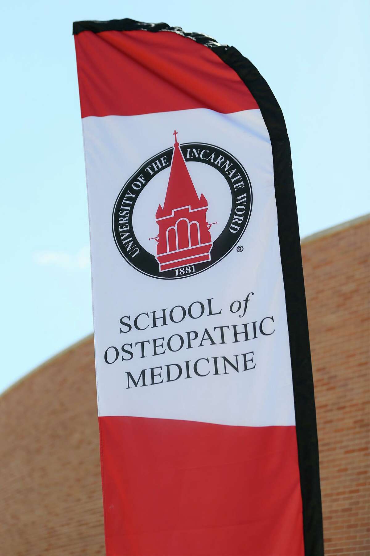 A banner flies outside UIW's School of Osteopathic Medicine at Brooks. On Friday, the university announced it has purchased seven building at South Side mixed-use development to house its health professions programs.