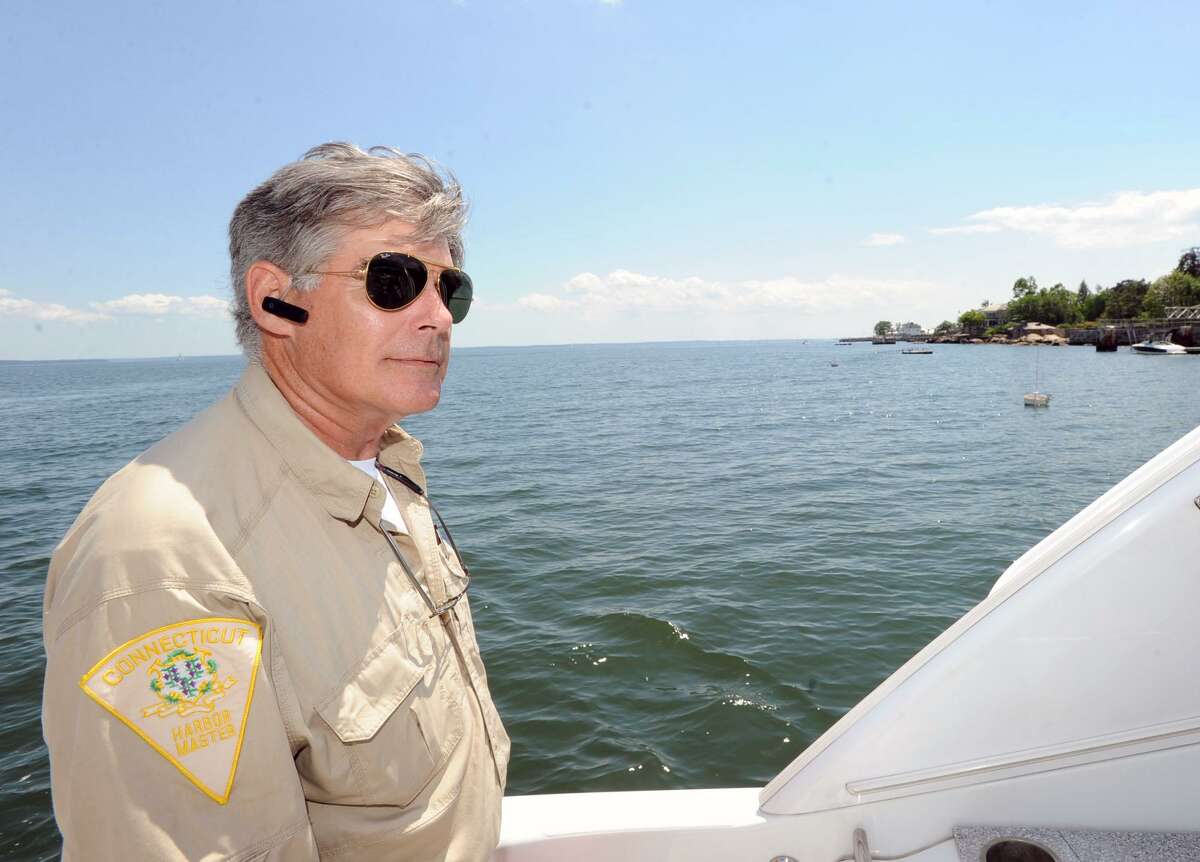 Greenwich Harbor Master Ian MacMillan, aboard the boat, Ice Fire, inspects moorings in a shellfish bed in the Long Island Sound off the coast of Greenwich, Conn., Friday afternoon, June 27, 2014.