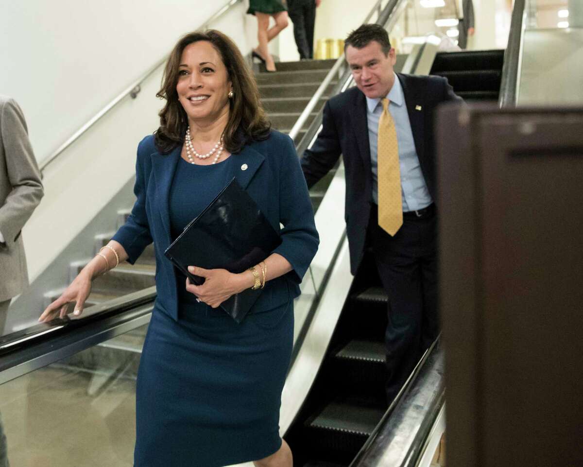 Sen. Kamala Harris, D-Calif., followed by Sen. Todd Young, R-Ind., leave the Senate after final votes for the week, on Capitol Hill in Washington, Thursday, July 20, 2017. (AP Photo/J. Scott Applewhite)