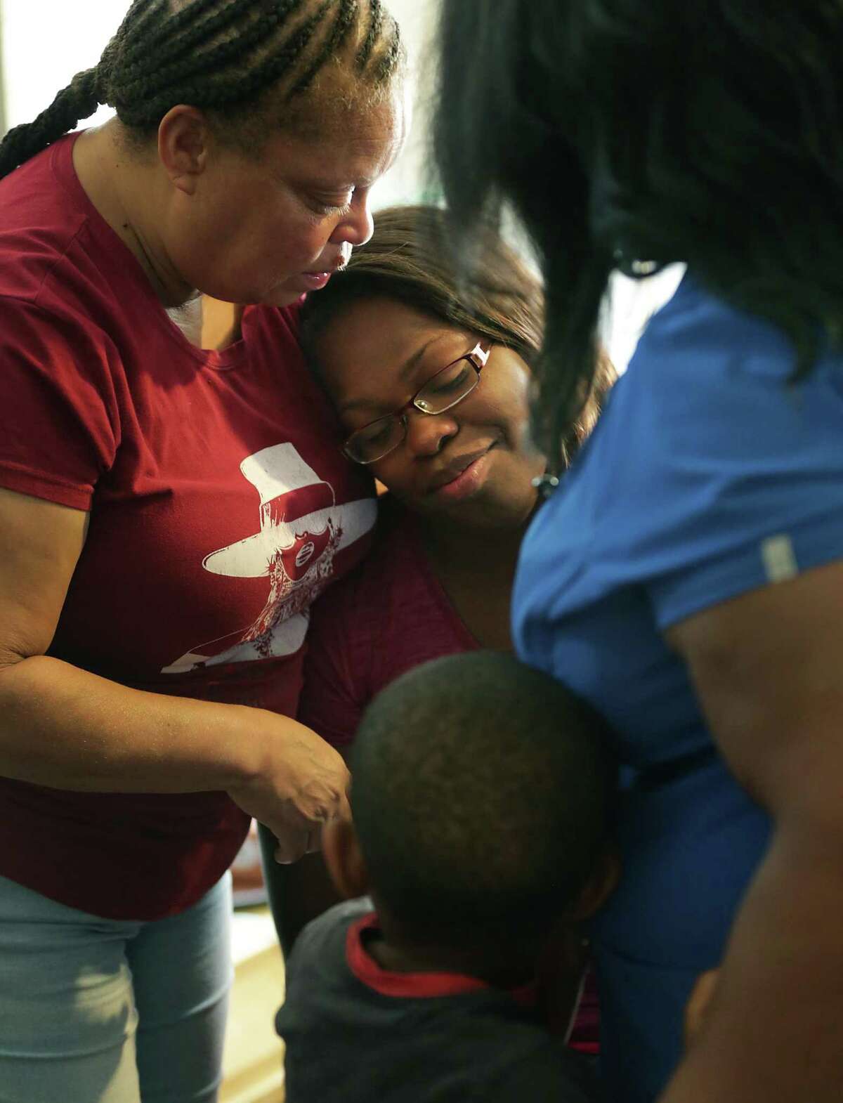 Cyntwanisha Whitley, center, mother of 4 year-old De-Earlvion Whitley who was killed in a drive-by shooting, is comforted by her mother Temekia O'Cnnor, left, and Tamika Hawkins, right, as family members and friends gather to support each other July 20, 2017.