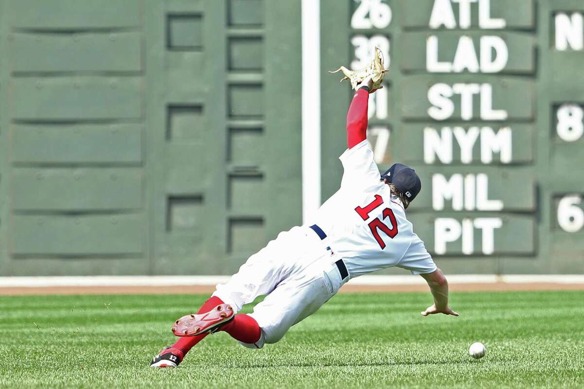 BOSTON, MA - JULY 20: Brock Holt #12 of the Boston Red Sox misses a fly ball hit by Steve Pearce #28 of the Toronto Blue Jays during the third inning at Fenway Park on July 20, 2017 in Boston, Massachusetts. (Photo by Maddie Meyer/Getty Images) ORG XMIT: 700011676
