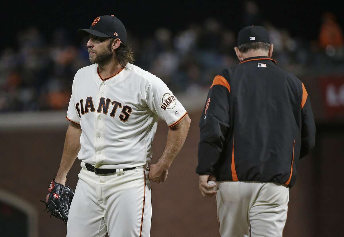 San Francisco Giants starting pitcher Madison Bumgarner, left, walks to the dugout after being removed by manager Bruce Bochy, right, during the seventh inning of the team's baseball game against the San Diego Padres on Thursday, July 20, 2017, in San Francisco. (AP Photo/Eric Risberg)