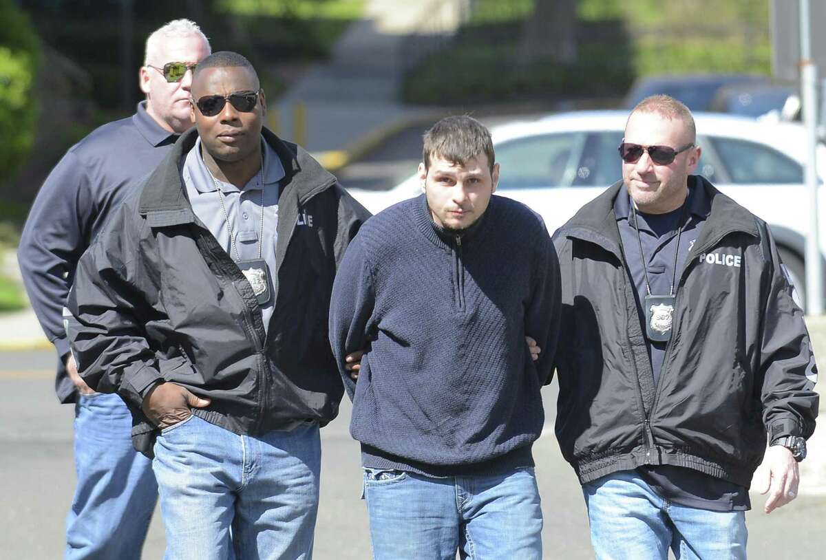 Investigators Jerry Junes and Edward Davis, followed by Sgt. Chris Broems walk Joseph Boccuzzi, of Norwalk, into the rear of Stamford police headquarters on Friday, April 14, 2017. Boccuzzi is charged with robbing Springdale?’s First County Bank in November 2016 and February 2017.