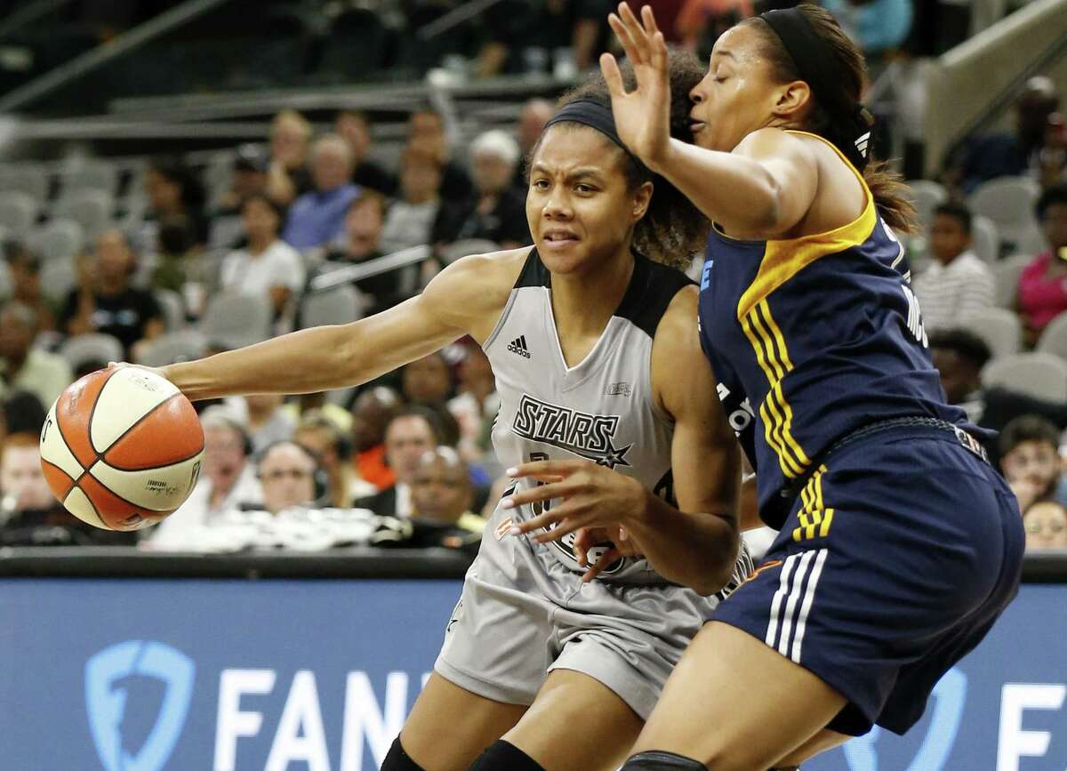 Stars’ Nia Coffey looks for room around the Indiana Fever’s Erica McCall during second half action on July 20, 2017 at the AT&T Center. The Stars won 85-61.
