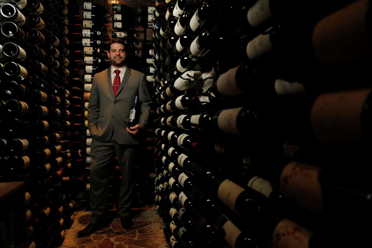 Adam Dolch with holds a bottle of Idus de Vall Llach wine in the wine cellar at Brenner's Steakhouse, Tuesday, June 7, 2016, in Houston. ( Karen Warren / Houston Chronicle )