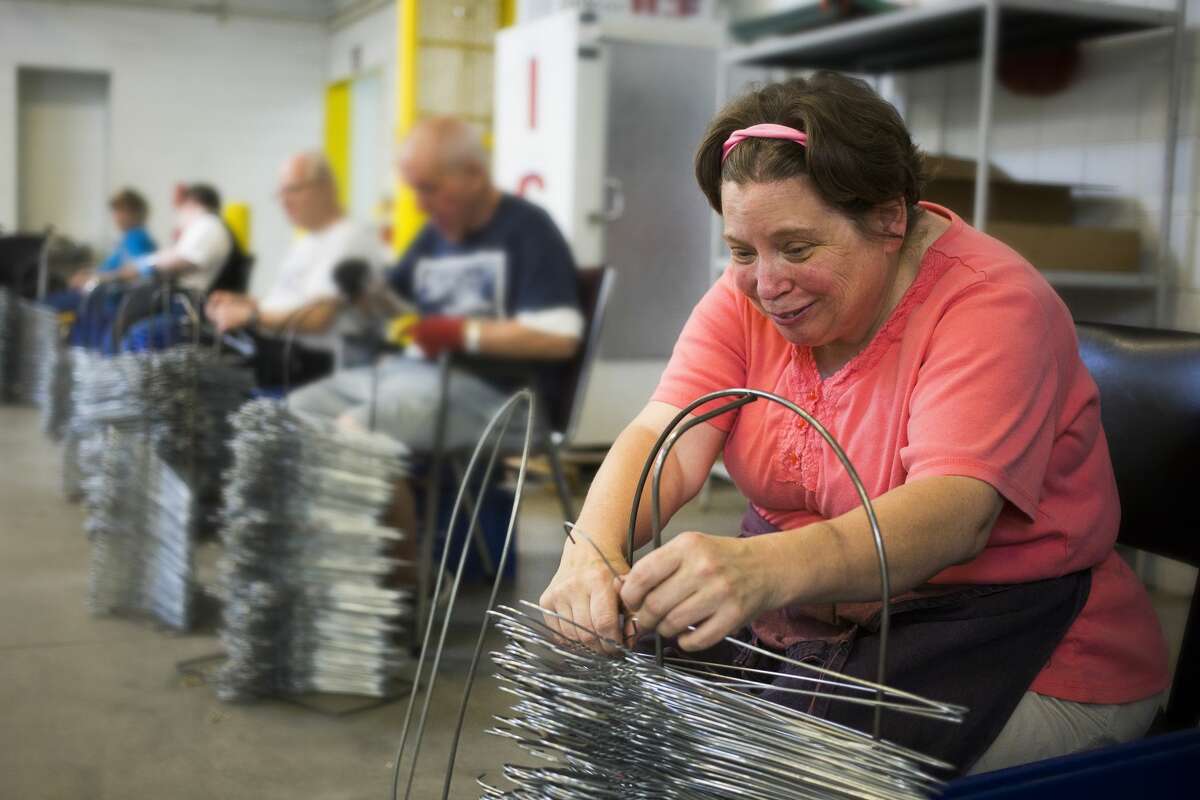 Karen Funk checks metal hangers for quality control as part of her job at the Arnold Center on Thursday. The Arnold Center provides services and support to people with disabilities and/or other unique needs.