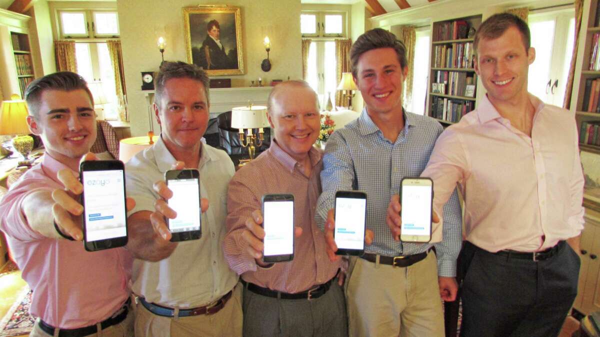 Hunt Scanlon Media showcases the firm's newest product, job search platform Ezayo, on their mobile phones at the company's offices, located in Greenwich, Conn., on Wed., July 19, 2017. From left to right: Hunt Scanlon Director of Marketing and Brand Management Mike Hawkins; Co-founder and CEO Scott Scanlon; Co-founder and President Chris Hunt; Director of Digital Platform Communications Andrew Mitchell; Chief Digital Officer Mike Wasulko.