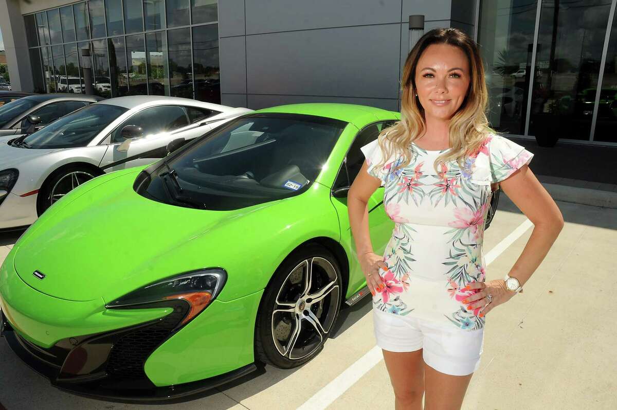 Heather Cline-Wehrly sports a manicure with the McLaren "swoosh" next to her 650S at McLaren Houston. Cline-Wehrly and other supercar owners headed to the Senna: Driving Instinct event in Austin.