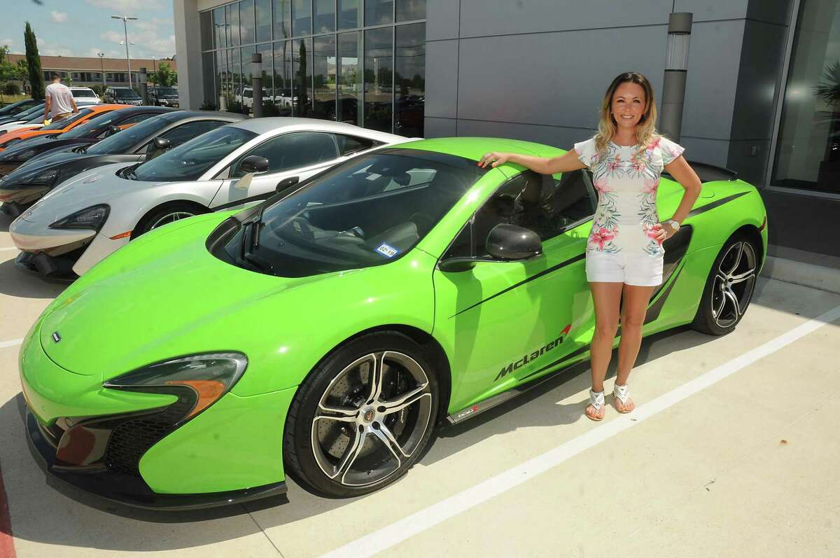 Heather Cline-Wehrly poses with her 650s at McLaren Houston on the North Freeway Friday July 14, 2017. Cline-Wehrly and other supercar owners headed to the Senna: Driving Instinct event at Circuit of the Americas in Austin.(Dave Rossman Photo)