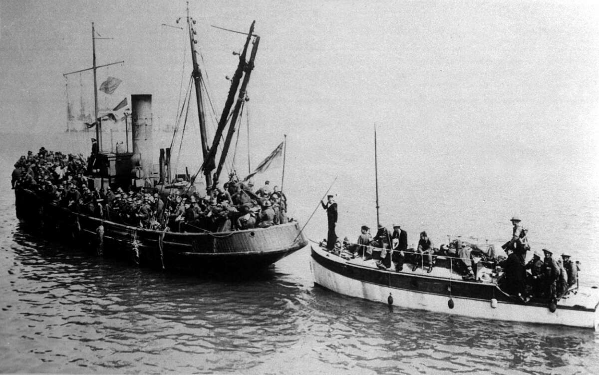 British soldiers are packed on a tug and a small powerboat as they evacuate Dunkirk, France, in June 1940.