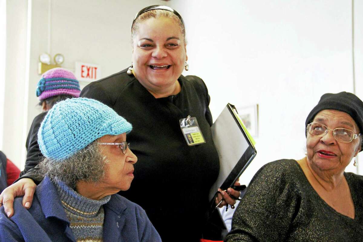 New Haven's Director of Elderly Services Migdalia Castro (center) talks to Barbara Jennings (left) and Shirley McCoy on Wednesday, Jan. 20, at the Atwater Senior Center in New Haven. Esteban L. Hernandez New Haven Register