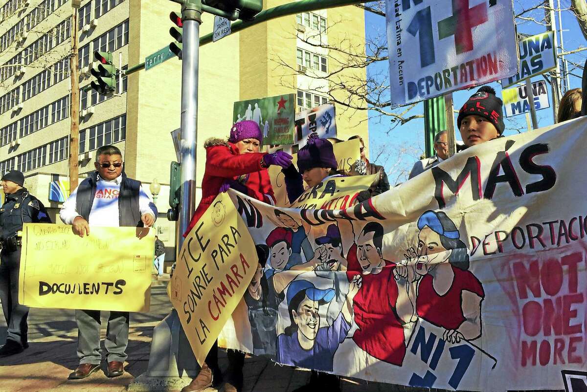 Demonstrators gather near the corner of Ferry Street and Grand Avenue on Wednesday, Jan. 6, in Fair Haven, as part of an anti-deportation rally. (Esteban L. Hernandez - New Haven Register)