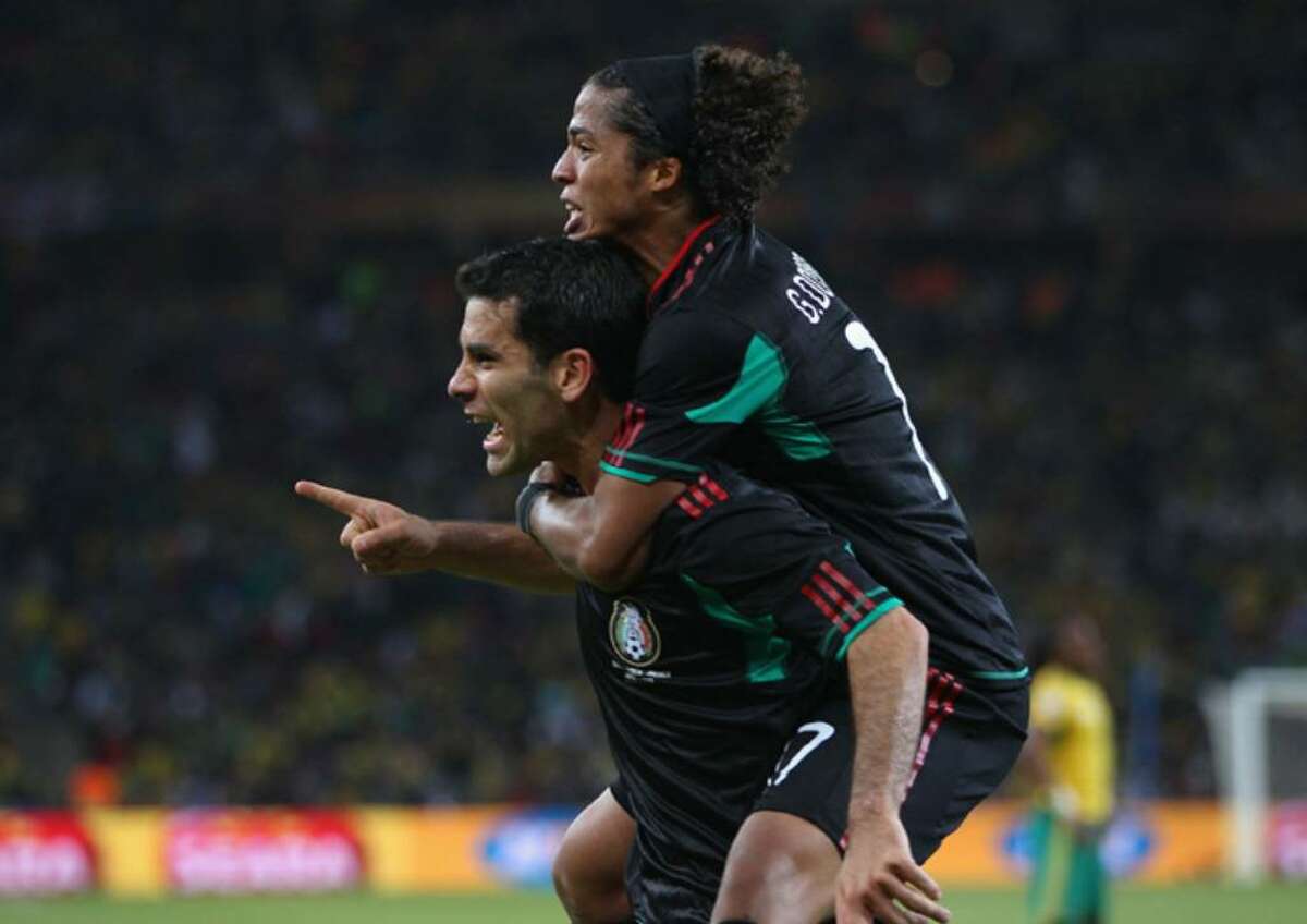 JOHANNESBURG, SOUTH AFRICA - JUNE 11: Giovani Dos Santos of Mexico celebrates with Rafael Marquez of Mexico after he scored the second goal to equalise during the 2010 FIFA World Cup South Africa Group A match between South Africa and Mexico at Soccer City Stadium on June 11, 2010 in Johannesburg, South Africa. (Photo by Michael Steele/Getty Images) *** Local Caption *** Rafael Marquez;Giovani Dos Santos