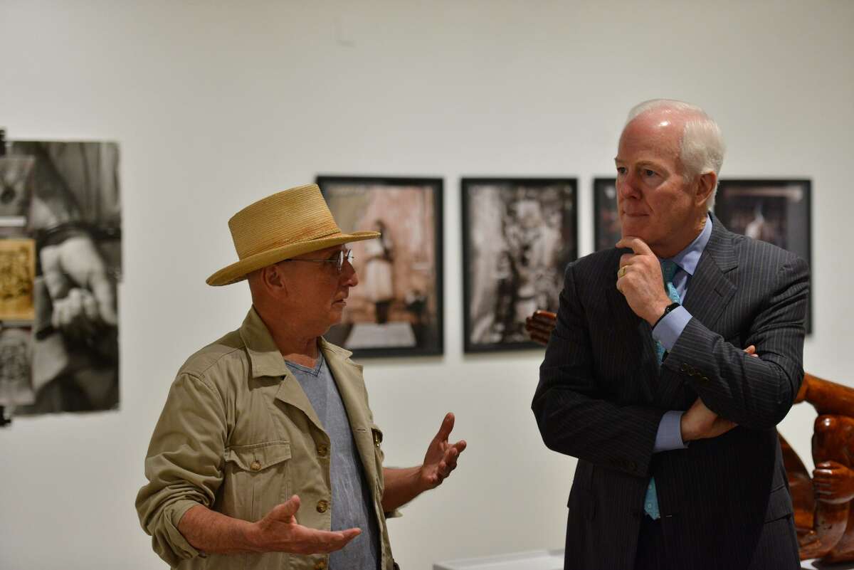 Sen. John Cornyn talks with artist Cesar Martinez during a tour of the “Icons and Symbols of the Borderland" exhibit Friday at Centro de Artes.
