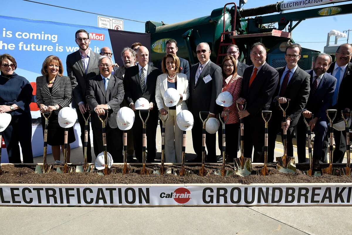 The group of dignitaries poses for a picture during a groundbreaking ceremony and event for Caltrain's electrification and modernization project, at the Caltrain Station in Millbrae, CA, on Friday July 21, 2017.