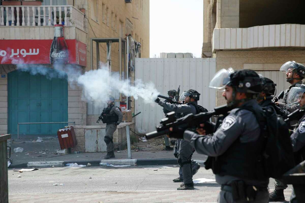 Israeli ﻿police fire tear gas at Palestinians during clashes in﻿﻿ Bethlehem. Tensions have risen after ﻿ police ﻿restricted Muslim access to a ﻿holy shrine.﻿