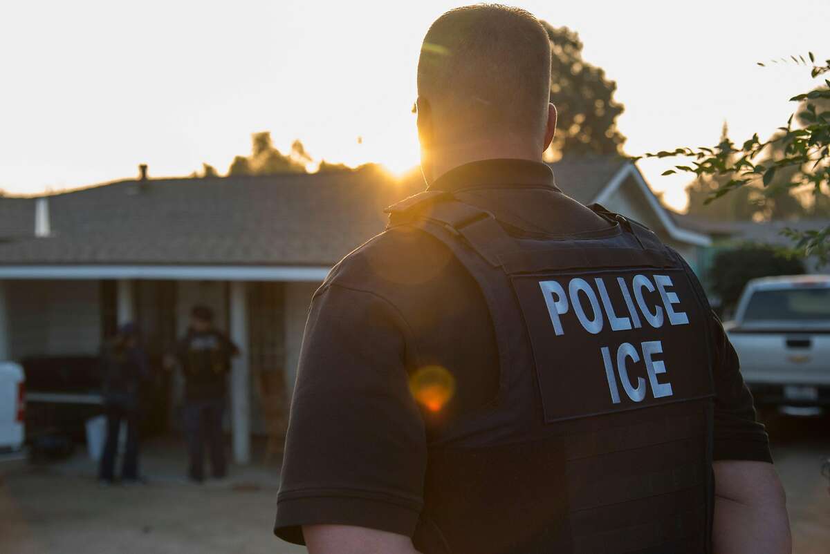 FILE - Immigration and Customs Enforcement agents after a predawn raid that failed to capture their target, in Riverside, Calif., June 22, 2017. 