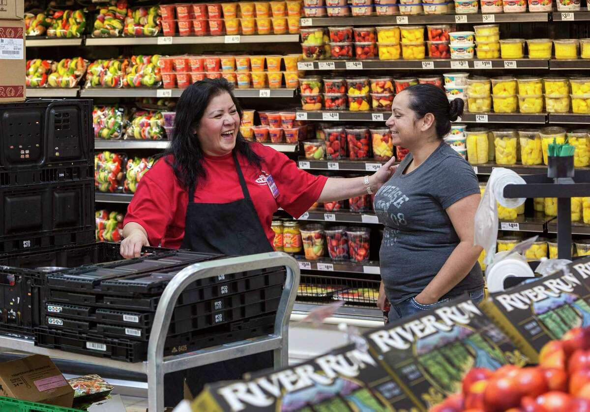 For Chon 100 special section on top performing companies. H-E-B at 28550 Highway 290, Cypress, Texas. ID: Joann Martinez restocks the fruit and produce section of HEB while joking with Niyeli Kinney (an HEB employee who is there on her day off.) Wednesday 5/29/13 (Craig H. Hartley/For the Chronicle)