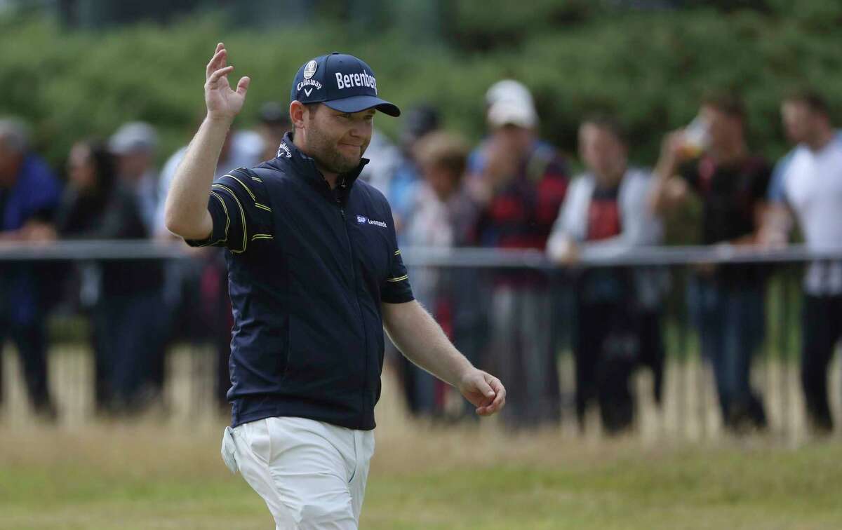 South Africa's Branden Grace waves as he makes his way along the 18th fairway during the third round of the British Open Golf Championship, at Royal Birkdale, Southport, England, Saturday July 22, 2017. (AP Photo/Peter Morrison)