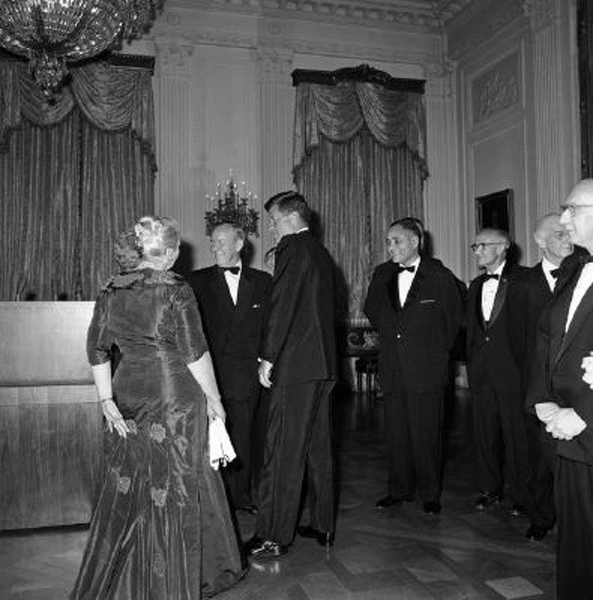 President John F. Kennedy and Lester Pearson, leader of Canadas Liberal Party and winner of the 1957 Nobel Peace Prize, talk at the White House, Washington, April 29, 1962 with Pearl Buck, back to camera, and Pearson's wife Maryon, before a White House dinner honoring Nobel Prize winner of the western Hemisphere.