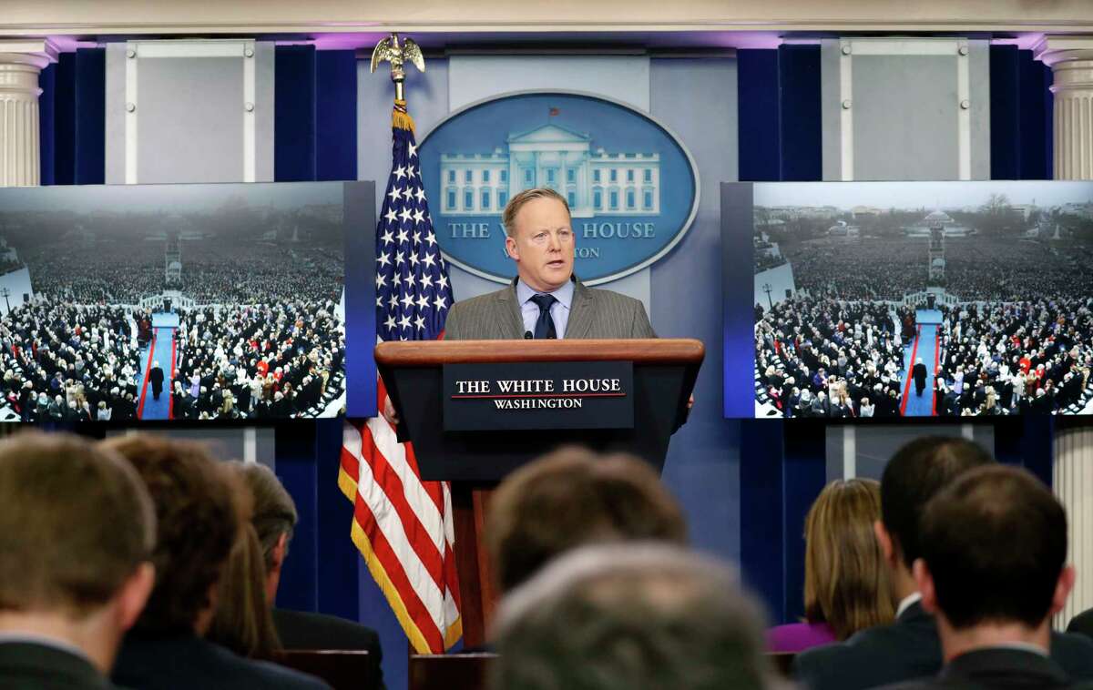 FILE - In this Jan. 21, 2017, file photo, White House press secretary Sean Spicer, flanked by images of then President-elect Donald Trump arriving during the 58th Presidential Inauguration at the U.S. Capitol, speaks in the White House briefing room in Washington. Almost from Day One, it was clear that Sean Spicer would ride a uniquely rocky and humiliating road as President Donald TrumpÂ?’s White House press secretary. (AP Photo/Alex Brandon, File)