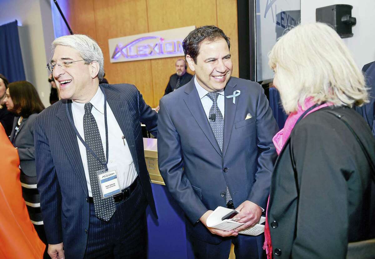 (Arnold Gold-New Haven Register) Left to right, Yale University President Peter Salovey, Alexion Pharmaceuticals CEO David Hallal and Commissioner of the Connecticut Department of Economic and Community Development Catherine Smith chat before the dedication ceremony for Alexion Pharmaceuticals global headquarters in New Haven on 2/29/2016.