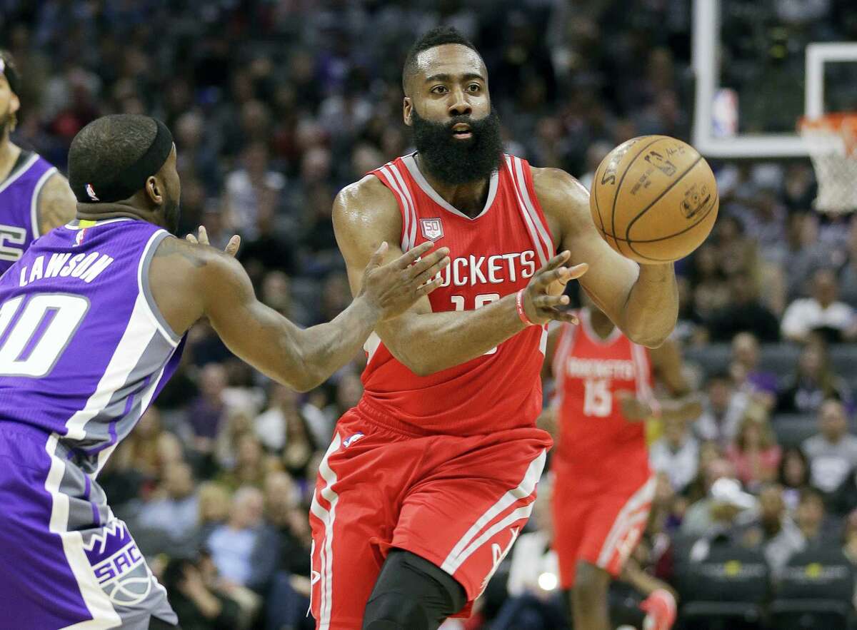 Houston Rockets guard James Harden, right, passes against Sacramento Kings guard Ty Lawson during the first half of an NBA basketball game, Sunday, April 9, 2017, in Sacramento, Calif. (AP Photo/Rich Pedroncelli)