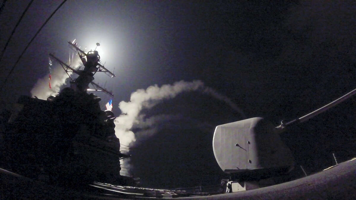 In this image provided by the U.S. Navy, the guided-missile destroyer USS Porter (DDG 78) launches a tomahawk land attack missile in the Mediterranean Sea, Friday, April 7, 2017. The United States blasted a Syrian air base with a barrage of cruise missiles in fiery retaliation for this week's gruesome chemical weapons attack against civilians. (Mass Communication Specialist 3rd Class Ford Williams/U.S. Navy via AP)
