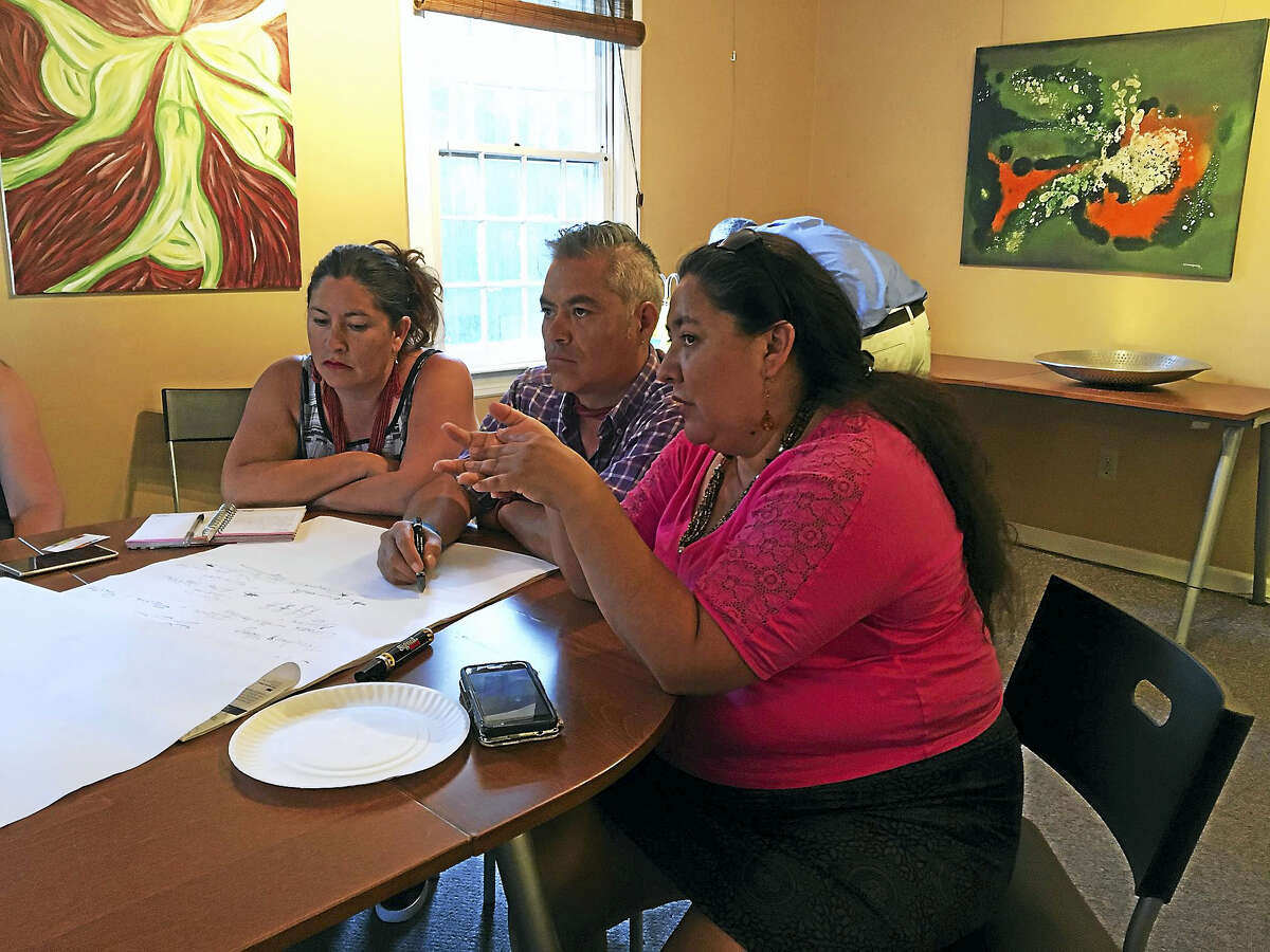 Mary O'Leary / Hearst Connecticut Media Fatima Rojas, right, translates for artist Emilio Herrera Corichi, center and his wife, Santa Rosa in New Haven. Herrera Corichi is designing a mural for the Strong School.