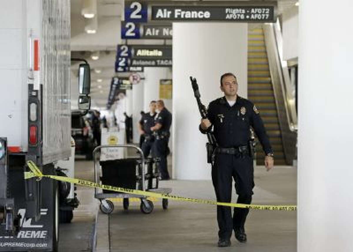 Police stand guard in Terminal 2 at Los Angeles International Airport on Friday, Nov. 1, 2013.