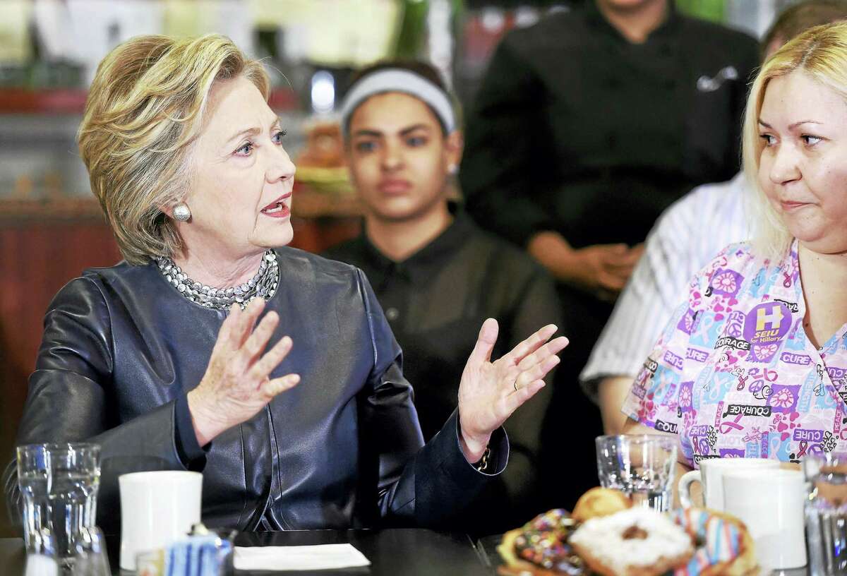 (Arnold Gold-New Haven Register) Democratic presidential candidate Hillary Clinton (left) speaks with Maribel Rodriguez (right), a Certified Nursing Assistant, during a campaign stop at Orangeside on Temple in New Haven, Connecticut, on April 23, 2016.