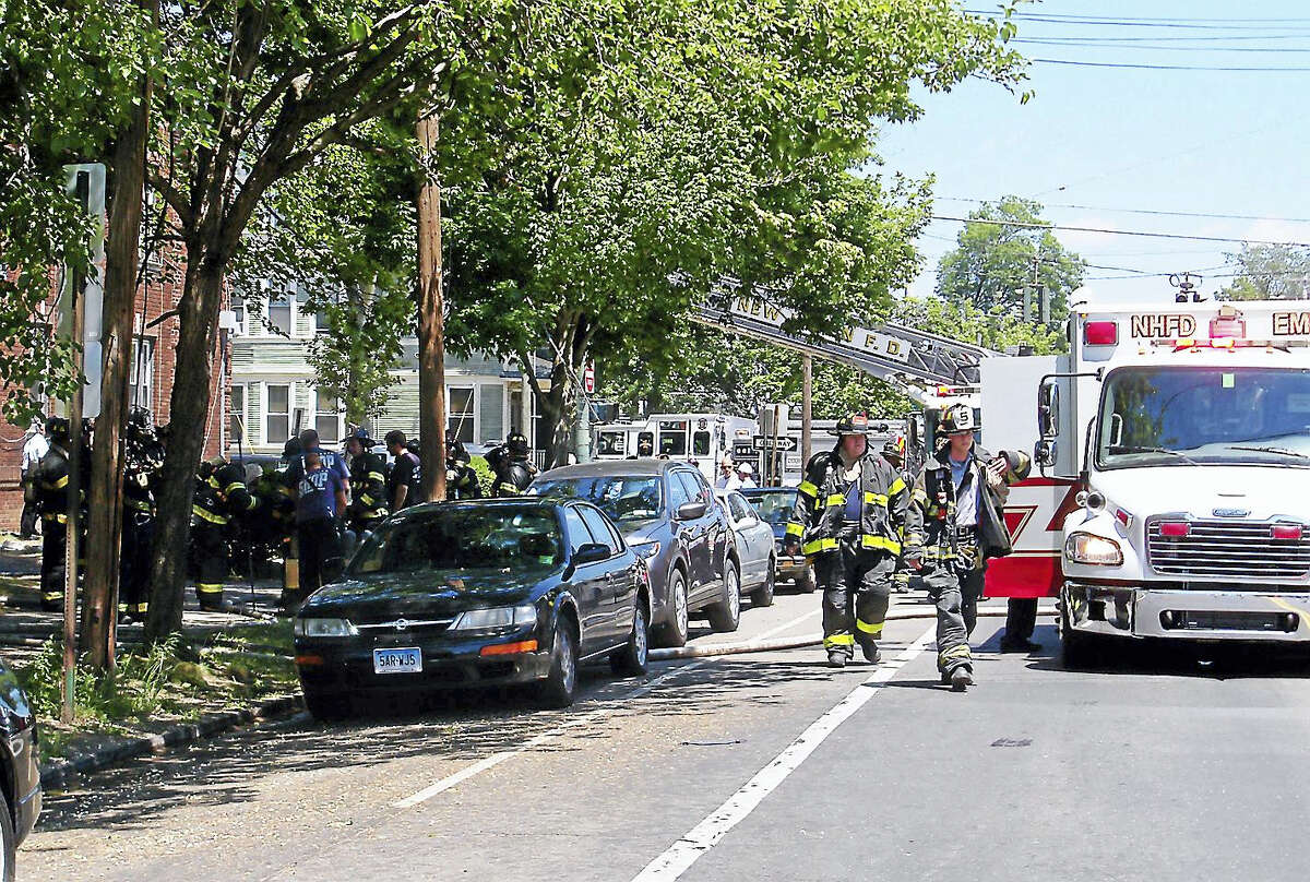 (Wes Duplantier/The New Haven Register)People were displaced from 10 apartment units after a two-alarm fire broke out at 202 Sherman Ave. No one was hurt in the fire but part of Sherman Avenue was shut down for hours as crews put out the flames, cleaned up and investigated.
