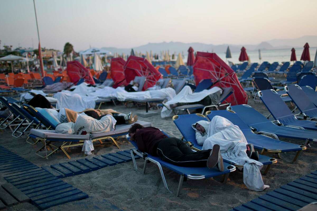 Tourists sleep on sun beds at a beach of the Greek island of Kos on Saturday, ﻿a night after an ﻿earthquake killed two tourists and injured nearly 500 others across the Aegean Sea region.﻿