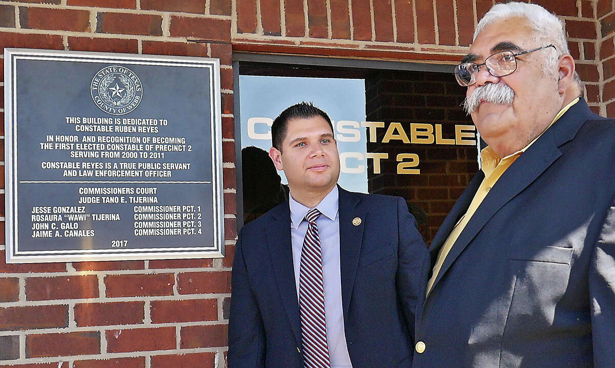 Former Webb County Precinct 2 Constable Ruben Reyes, right, and County Commissioner for Precinct 1 Jesse Gonzalez stand by a plaque dedicating the Constable Precinct 2 Building in honor of Reyes.