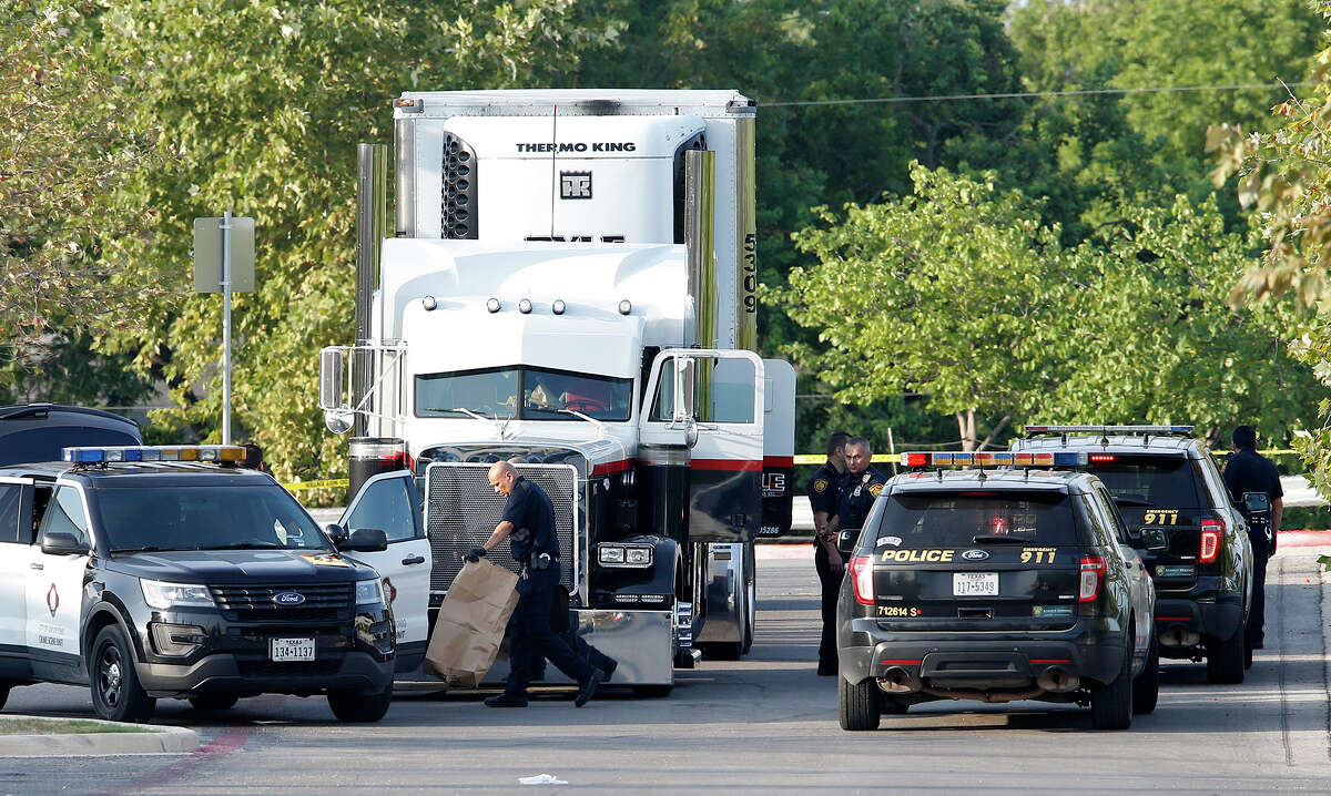 Law enforcement at the scene, where people were discovered inside a tractor trailer in a Walmart parking lot at IH35 South and Palo Alto Road, Sunday, July 23, 2017. Reports say that 8 were dead and several were in critical condition.