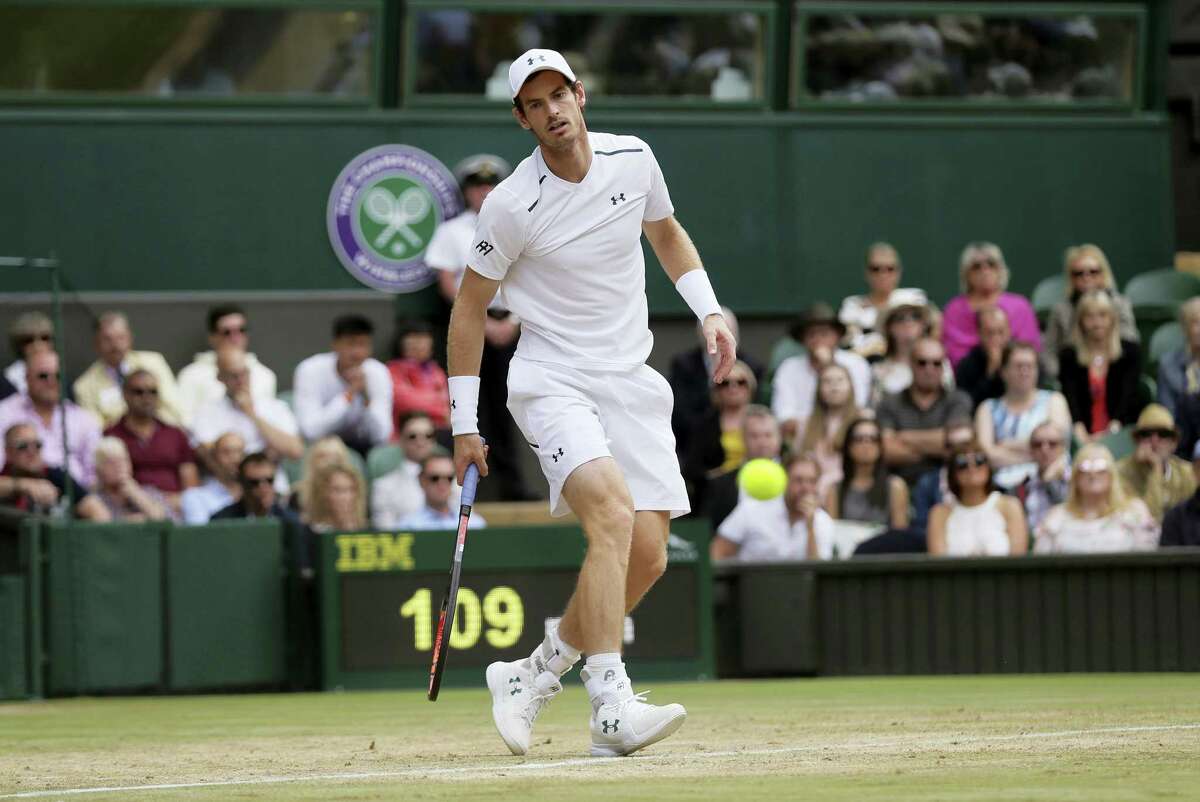 Andy Murray watches as a shot from Sam Querrey passes by him during their men’s singles quarterfinal match at Wimbledon on Wednesday.