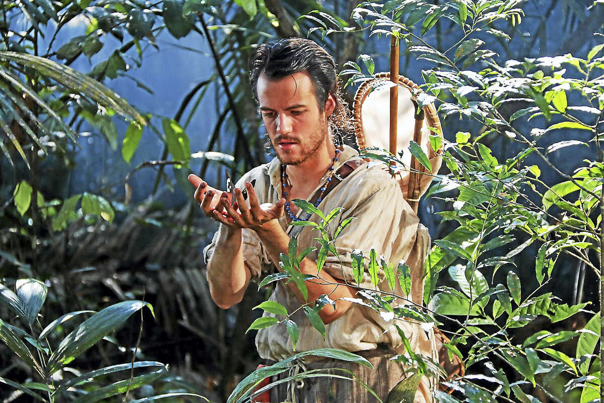 British naturalist Henry Bates (played by Calum Finlay) examines a rainforest butterfly in a scene from “Amazon Adventure,” a new IMAX movie opening this weekend on the six-story screen of The Maritime Aquarium at Norwalk.