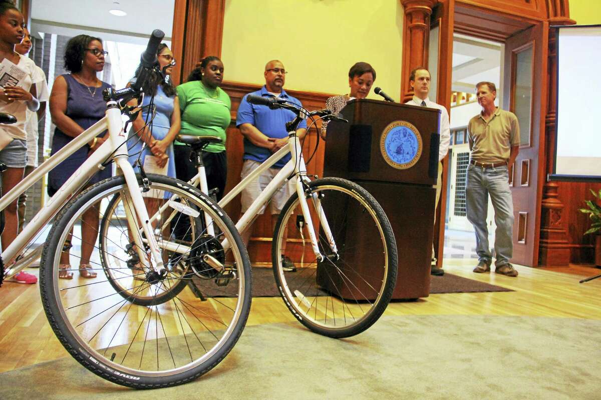 Bikes used by the Youth Conservation Corps members placed near Mayor Toni Harp during a press conference on the city’s sustainability efforts Wednesday at City Hall.