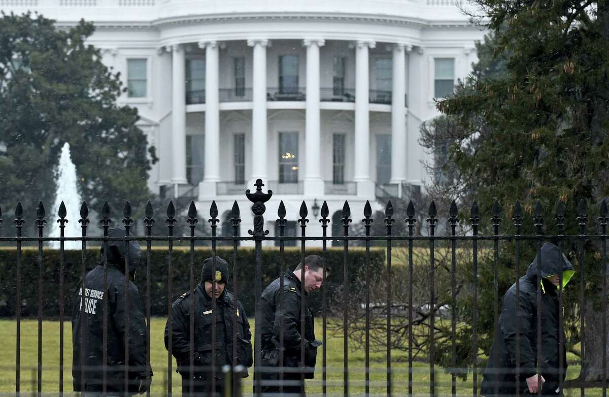 Secret Service officers search the south grounds of the White House in Washington.