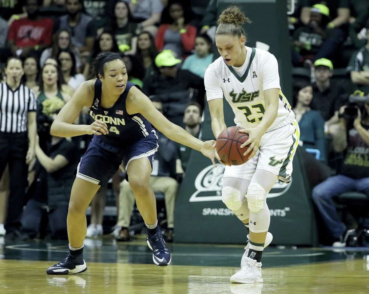 Connecticut guard/forward Napheesa Collier (24) tries to steal the ball from South Florida forward Tamara Henshaw (23) during the first half of an NCAA women’s college basketball game, Monday, Feb. 27, 2017, in Tampa, Fla. (AP Photo/Chris O’Meara)