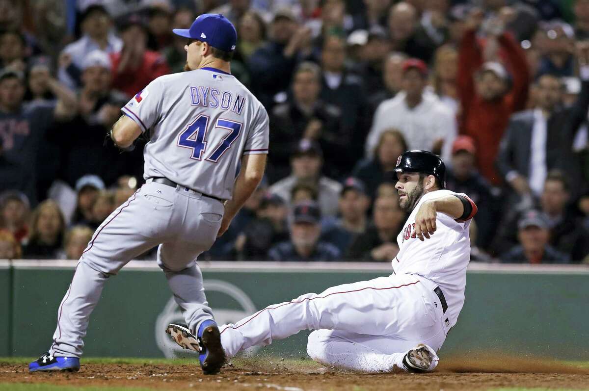 Boston Red Sox’s Mitch Moreland scores on a wild pitch by Texas Rangers relief pitcher Sam Dyson (47) during the seventh inning of a baseball game at Fenway Park in Boston, Wednesday.