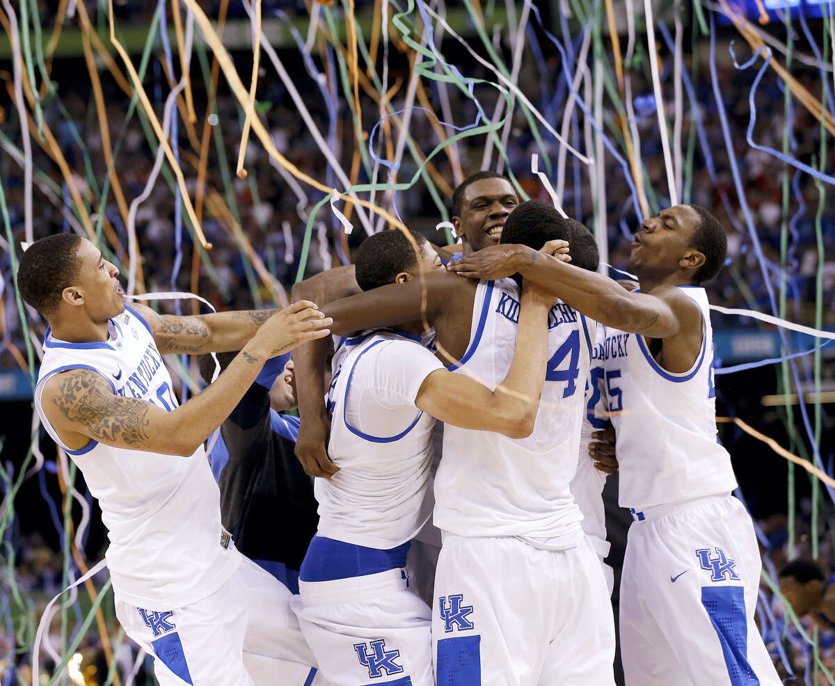 In this April 2, 2012, file photo, Kentucky players celebrate ITS NATIONAL CHAMPIONSHIP against Kansas. The Associated Press is ranking the top 100 college basketball programs of all time using 68 years of data from the AP Top 25 poll.
